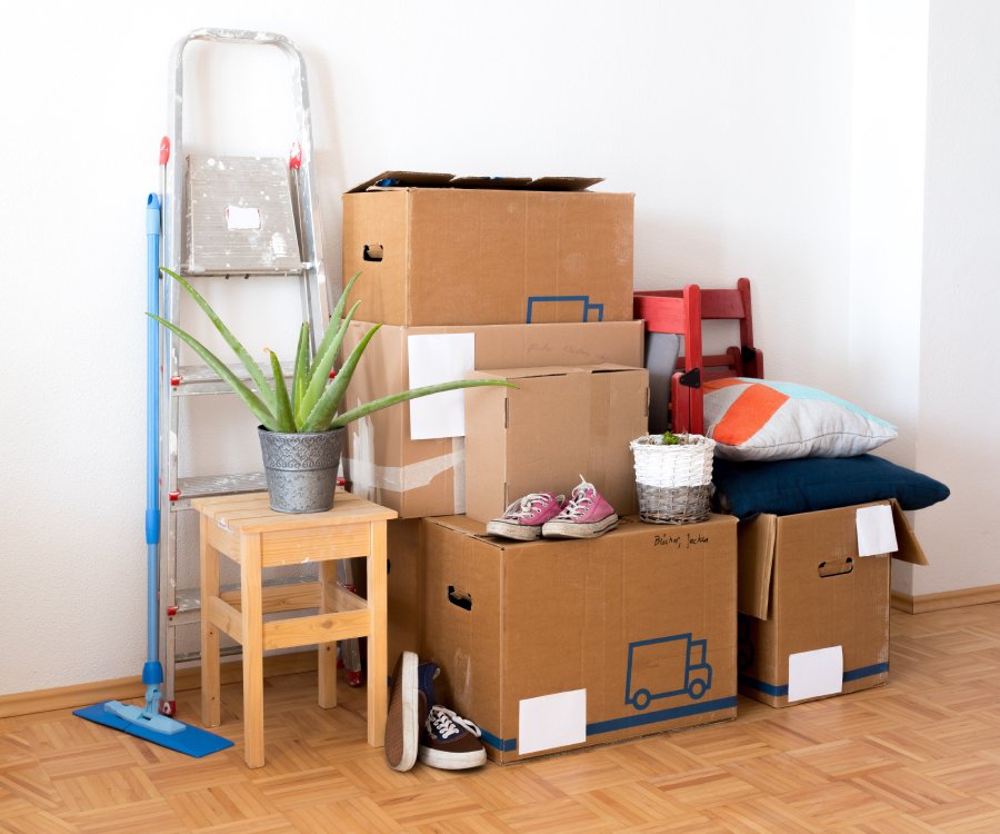 Boxes and household items stacked in a room during a move-out.